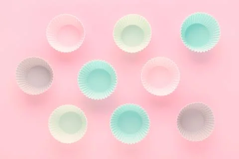 Silikone forms for baking muffins and cupcakes on pastel pink background Stock Photos