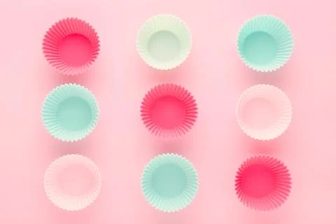 Silikone forms for baking muffins and cupcakes on pastel pink background Stock Photos