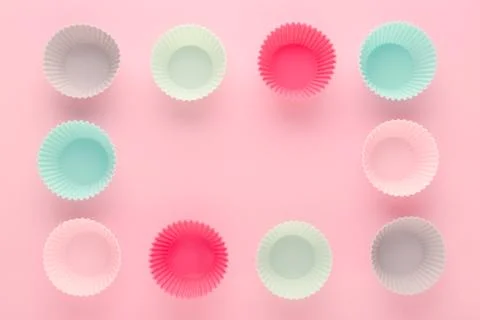 Silikone forms for baking muffins and cupcakes on pastel pink background Stock Photos