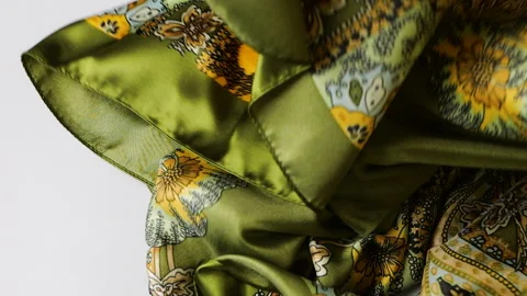 Silk fabric gently falls onto a clean white background in slow motion.  Stock Footage 337404363