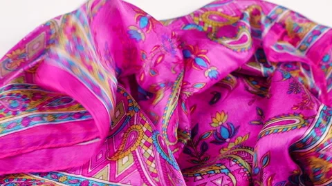 A silk scarf with colorful patterns drops smoothly down in slow motion.  Stock Footage 337404691