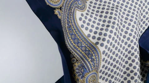 A silk scarf with a traditional paisley pattern falls gently. Stock Footage 337402478