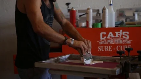 Silk Screen printing manufacturing on t-shirts print Stock Footage 76842643