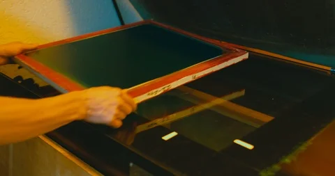 Silk screen printing process - forming a stencil from a screen with of a piece o Stock Footage 95334477