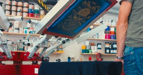 Silk screen printing process - making a print on a t-shirt. 4K UHD Stock Footage 95352233
