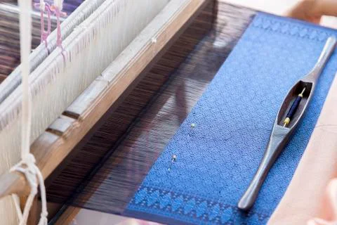 Silk string to make homemade textile Thai pattern style with weaving machine. Photos