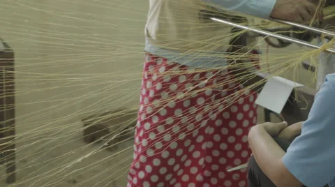 Silk thread being combined by hand to make fabric in Cambodia Stock Footage 48011605