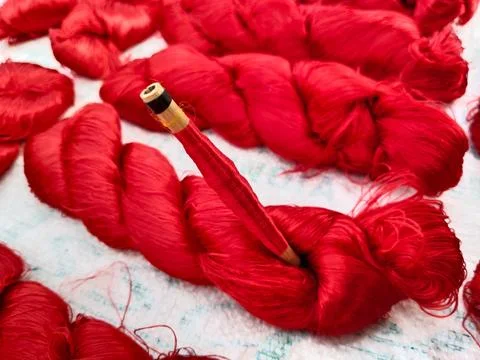 Silk thread reel or spindle silk. lot of bundles of natural colored raw sil.. Stock Photos