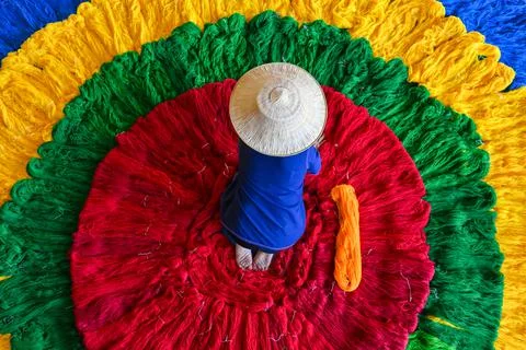 The silk weaver was preparing a roll of colorful silk threads before weaving  Stock Photos
