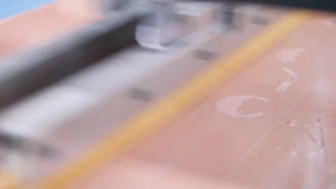 Silkscreen. the master applies paint through a stencil. product coloring. Stock Footage 233886385