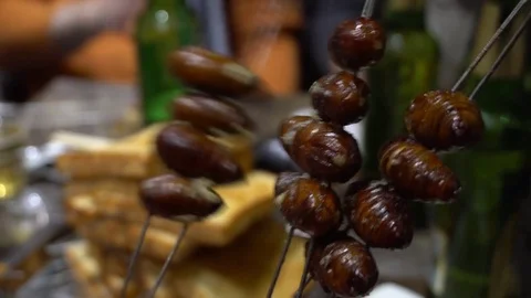 Silkworm larvae on a grill. An exotic dish. Chinese cuisine Stock Footage 72241663