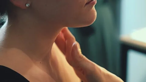 A silky serum is applied with fingertips. The model closes her eyes. Skincare Stock Footage 308469302
