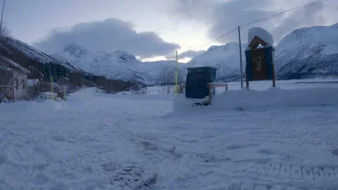 Silly and fun throwing residential garbage into bin with deep snow and Stock Footage 172205140