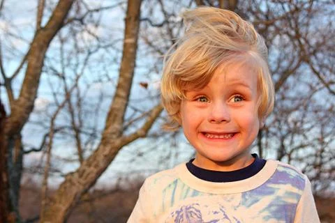 Silly boy smiling outside Stock Photos