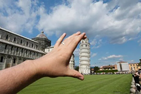 A silly fun false perspective view of the photographers hand holding the medi Stock Photos