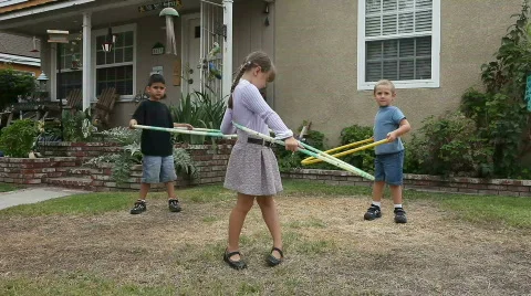 Silly Kids Hula Hooping Outdoors Stock Footage