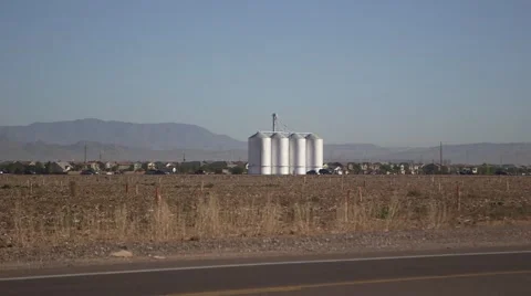 Silo on desert farm with mountain in view Stock Footage 44342434