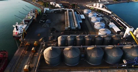Silos On Large Cargo Bay Unloading Ships Aerial Zoom Out Sunset Dock Stock Footage 300488524