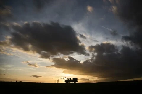 Silouette of VW -Bus infront oft stormy clouds, 4K Stock Footage 217375411