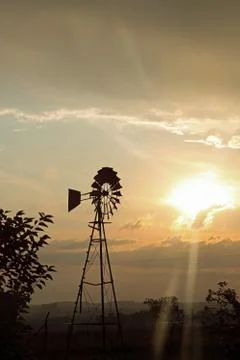 Silouette of a windpump at sundown Stock Photos