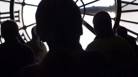 Silouettes in front of large clock PARIS, FRANCE 2/21/2015 Stock Footage 168540883