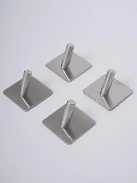 Silver adhesive wall hooks set of four Stock Photos