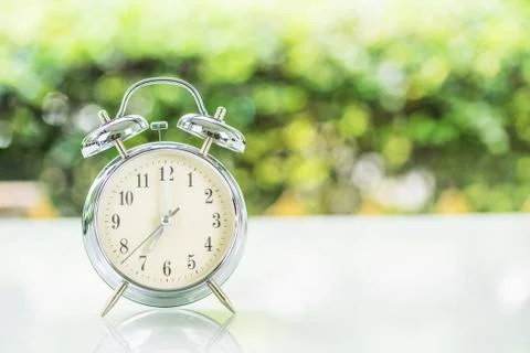 Silver alarm clock  on table Stock Photos