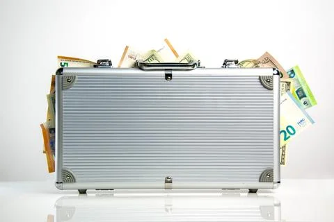 A silver aluminum briefcase with a slightly open latch and a few protruding.. Stock Photos