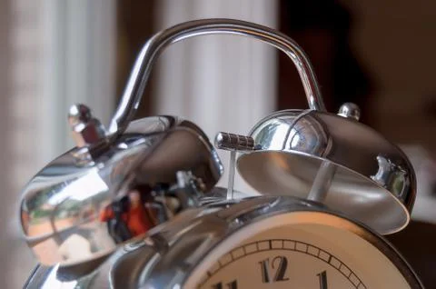 Silver analog alarm clock. Stock Photos
