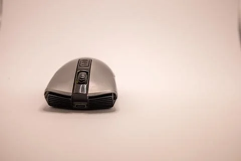 A silver and black wireless computer mouse with a DPI button and USB-C port,  Stock Photos