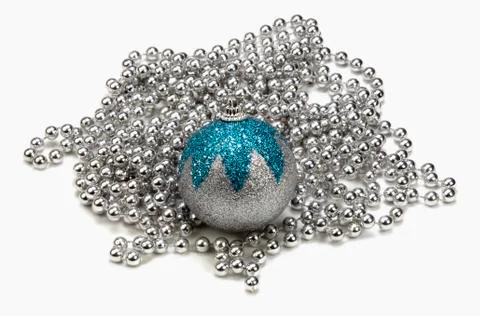 Silver and blue bauble on string of silver beads 스톡 사진