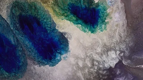 Silver and blue liquid glitter alcohol ink mix chemical reaction macro. Abstract Video stock 157618476