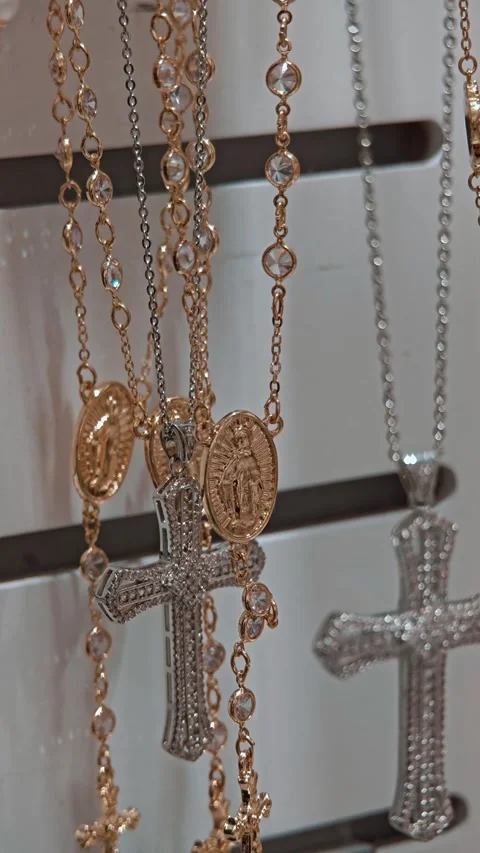 Silver and gold chains with cross pendants on showcase. Jewelry and symbolic Stock Footage 330788166
