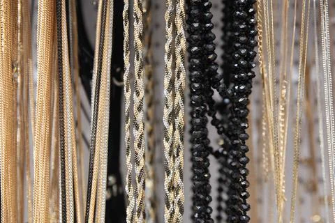 Silver and gold chains of different thickness Stock Photos
