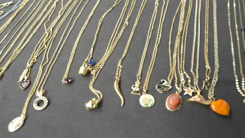 Silver and gold lockets on a display shelf. Stock Footage 111142955