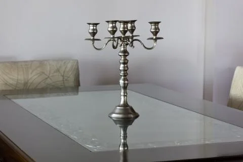 Silver antique candlestick on the table in a bright interior Foto stock