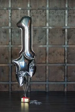 Silver ball in the form of number one with balls in the form of a star, tied to Foto stock
