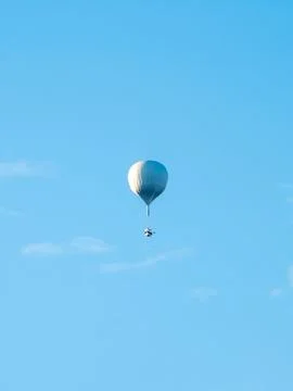 Silver balloon floats high in clear blue sky Photos