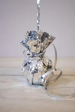 Silver balloon weights to keep balloons from flying into the sky. Stock Photos