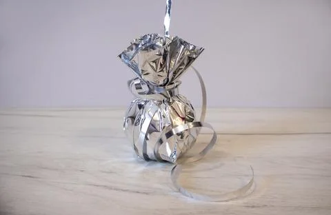 Silver balloon weights to keep balloons from flying into the sky. Stock Photos