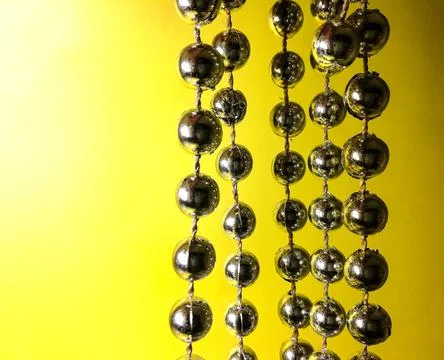Silver balls on a yellow background Foto stock