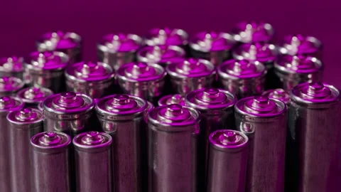 Silver batteries AA and AAA in neon light close-up. Double-A battery is a Stock Footage 279183615