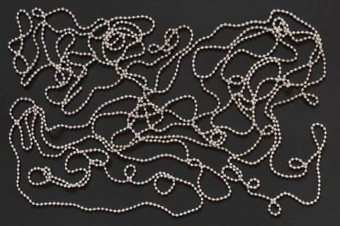 Silver beads on black background Stock Photos
