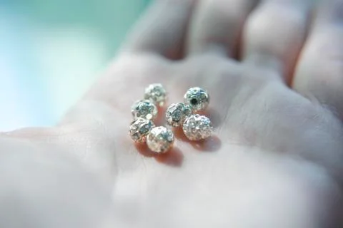 Silver beads with crystals on the hand Stock Photos