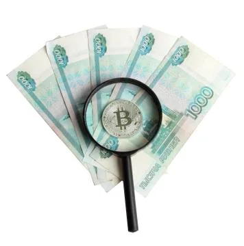 Silver bitcoin on the background of Russian banknotes Stock Photos