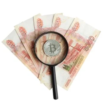 Silver bitcoin on the background of Russian banknotes Stock Photos