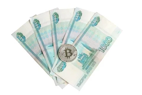 Silver bitcoin on the background of Russian banknotes Stock Photos