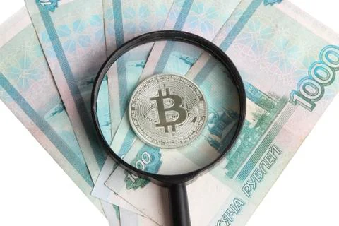 Silver bitcoin on the background of Russian banknotes Stock Photos