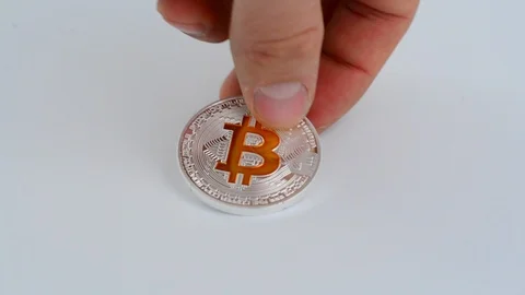 Silver bitcoin BTC coin on white background covered with one dollar bills. Stock Footage 99548425