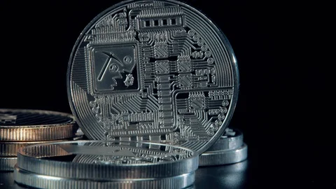 SIlver Bitcoin coin on black background. Silver Crypto coin on spinning stand. Stock Footage 126905049